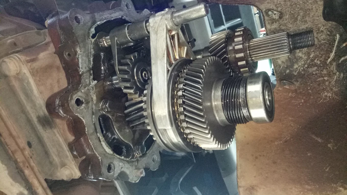 Opened manual gearbox showing gears and shaft