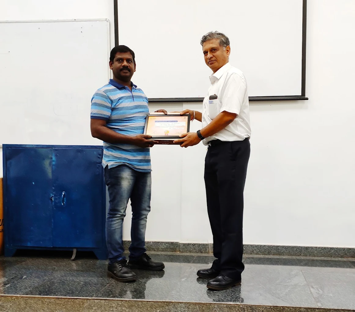 B. Ajay Kumar receiving a certificate of completion for manufacturer training